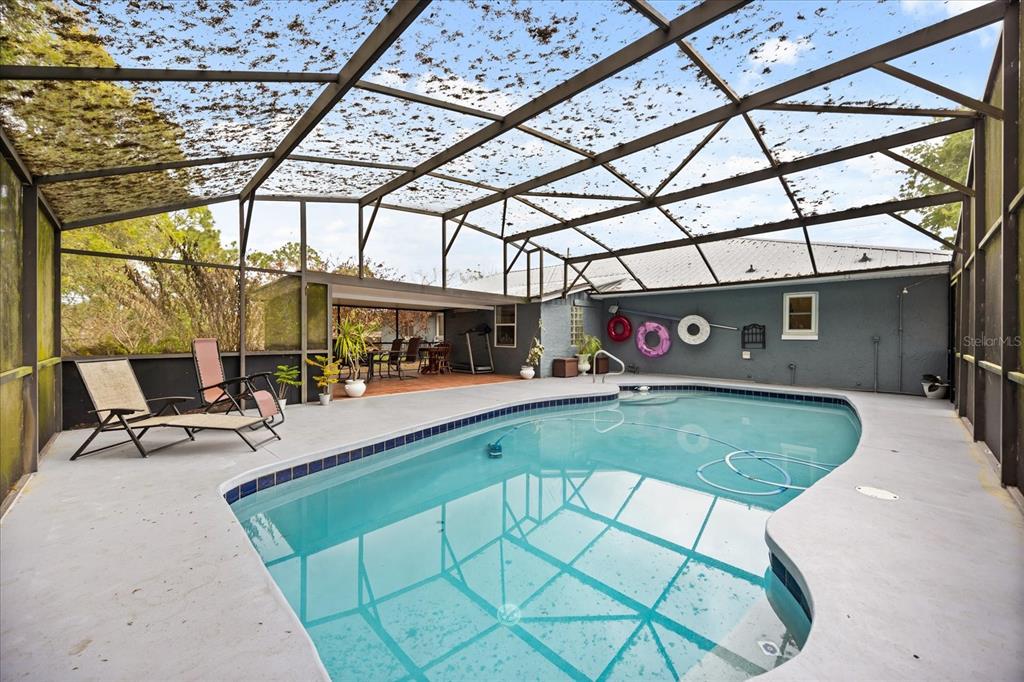 2270 Old Hickory Tree Road St. Cloud, FL 34772 - Photo 38 of 40 a view of a patio with a table and chairs