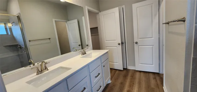 a bathroom with a double vanity sink and mirror