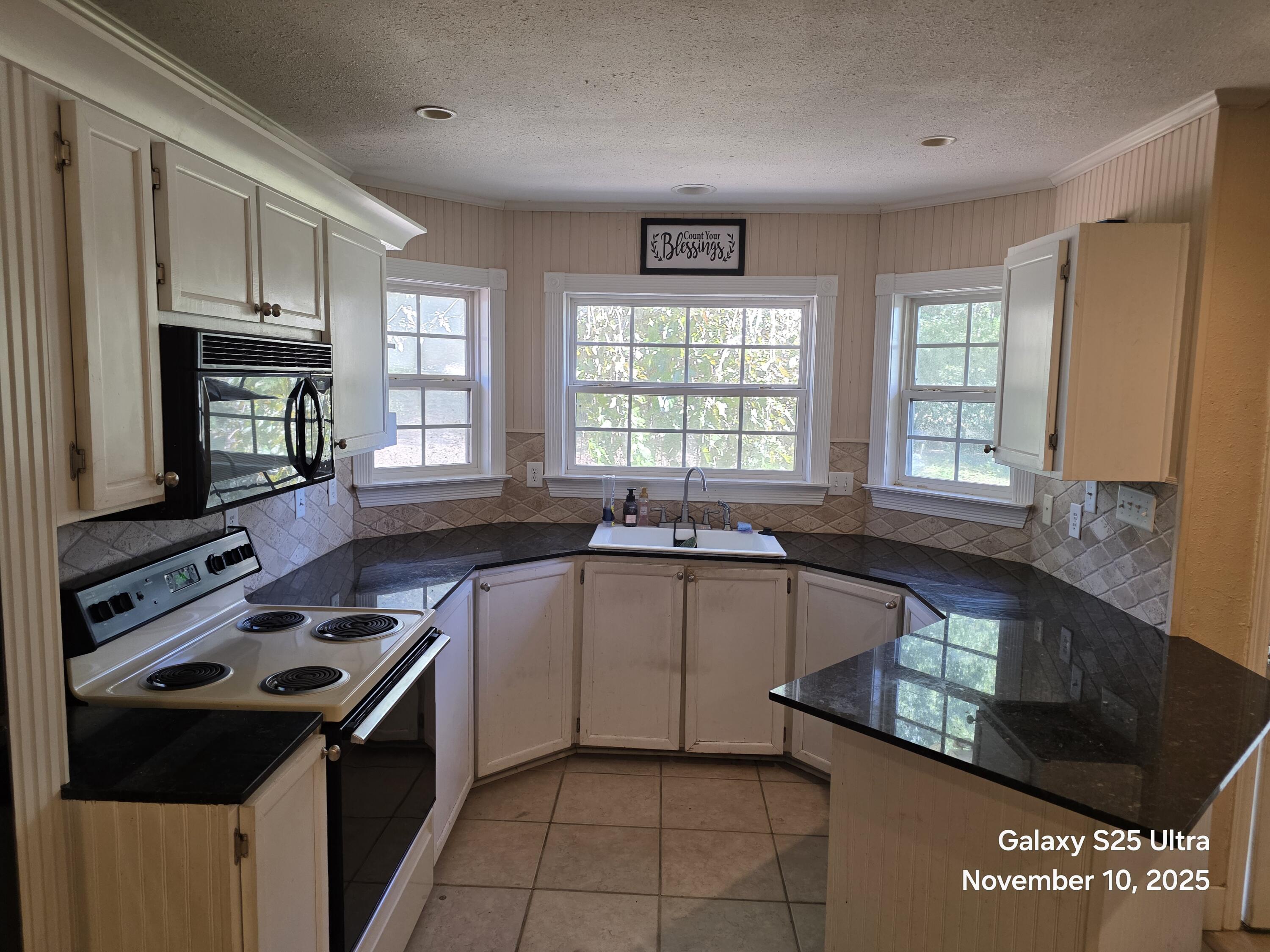 168 Ridge Lake Road Crestview, FL 32536 - Photo 2 of 11 a kitchen with a stove a sink and a microwave