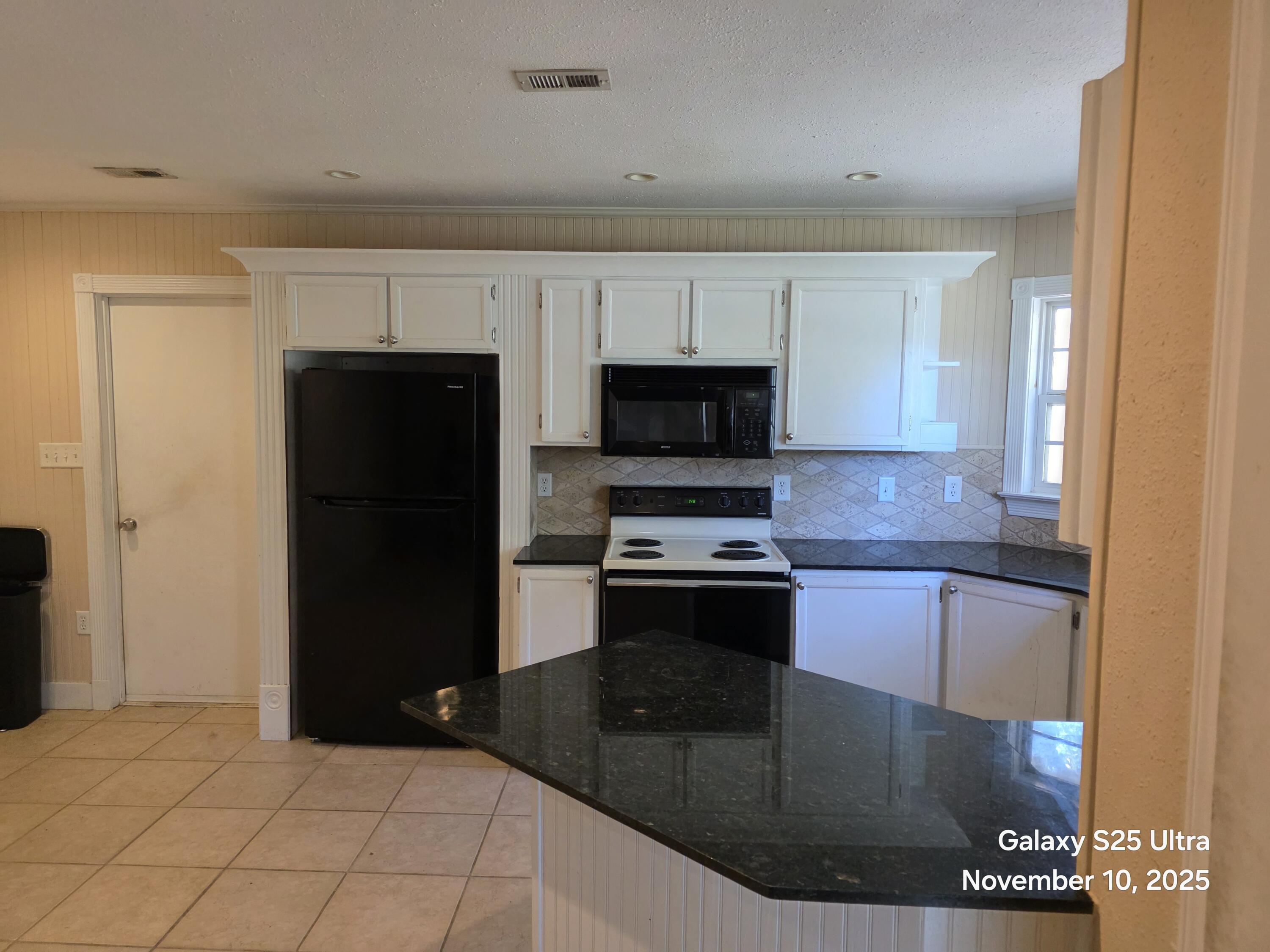 168 Ridge Lake Road Crestview, FL 32536 - Photo 3 of 11 a kitchen with stainless steel appliances granite countertop a refrigerator and a stove top oven