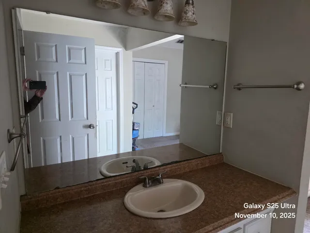 a bathroom with a sink and a mirror