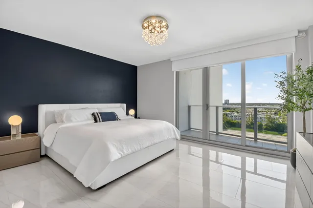 a bedroom with a bed and a large window