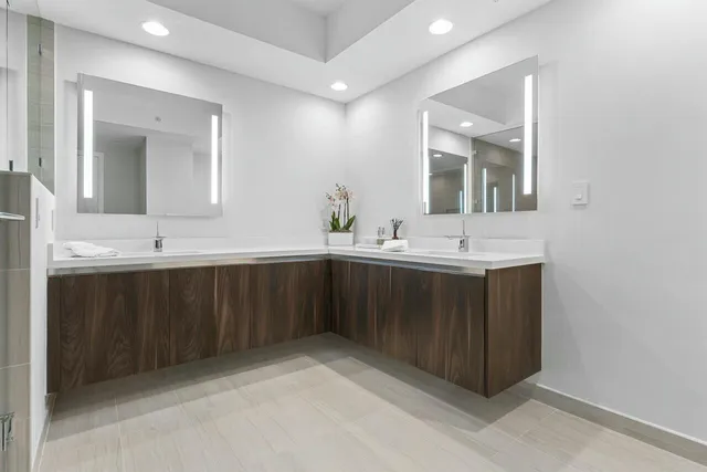 a bathroom with a double vanity sink mirror and