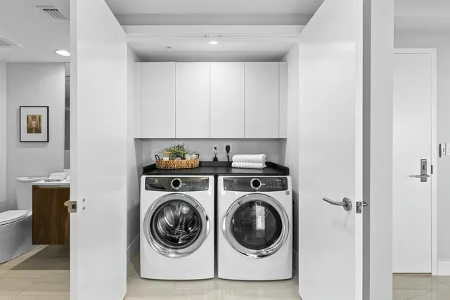 a utility room with sink dryer and washer