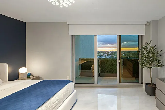 a bedroom with a bed and a large window