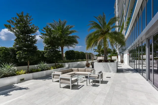 a view of a patio with a table and chairs under a umbrella