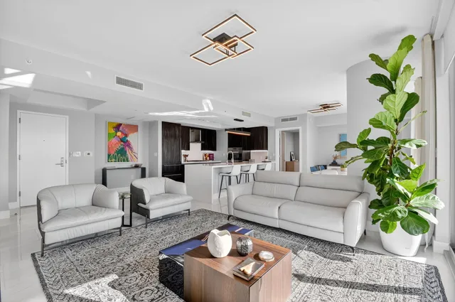 a living room with furniture or chandelier and a rug