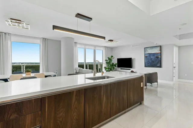 a large kitchen with a large counter top and sink