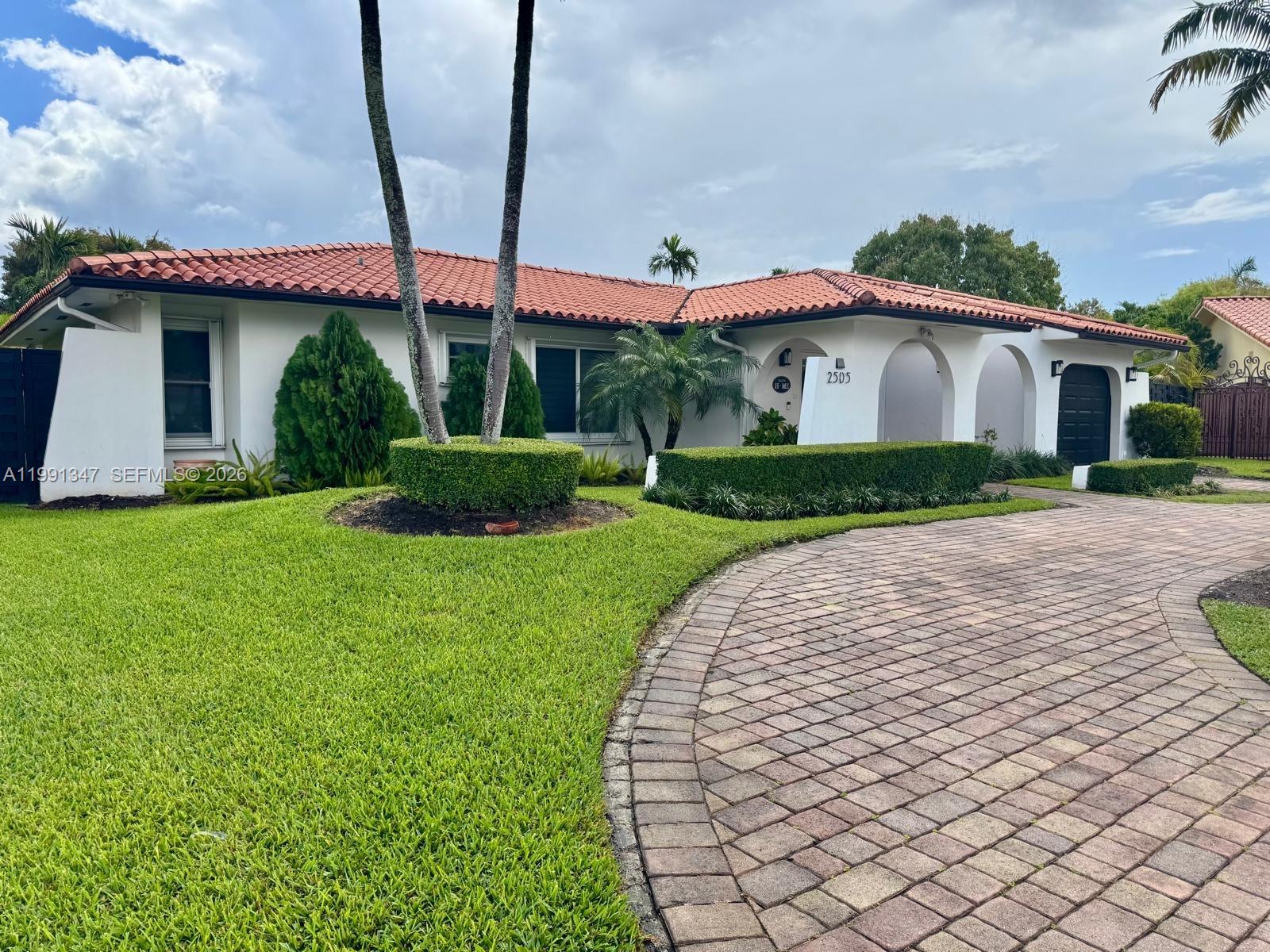 2505 Southwest 126th Avenue Miami, FL 33175 - Photo 1 of 22 a front view of a house with a yard and garage