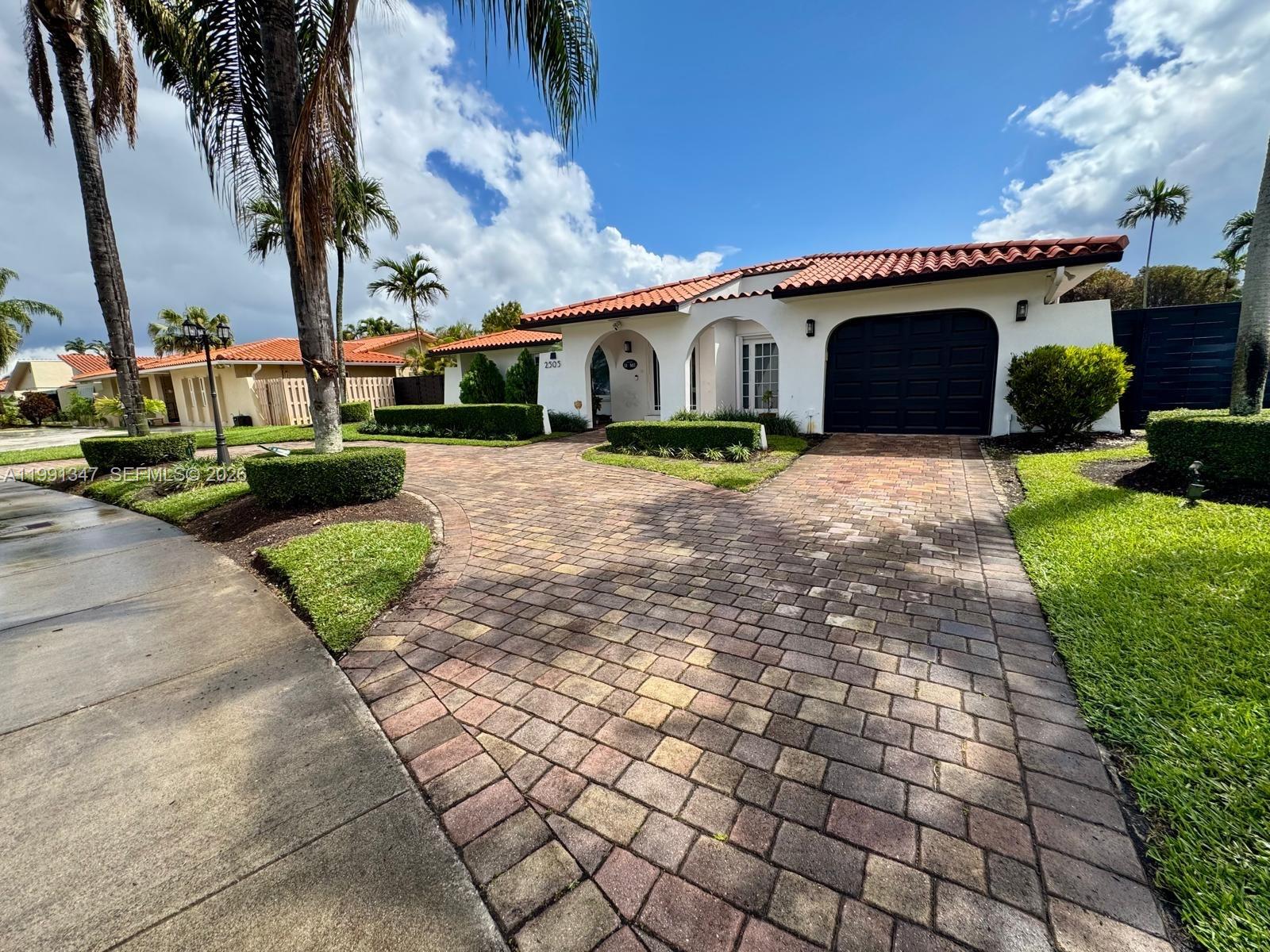 2505 Southwest 126th Avenue Miami, FL 33175 - Photo 2 of 22 a front view of a house with a garden and trees