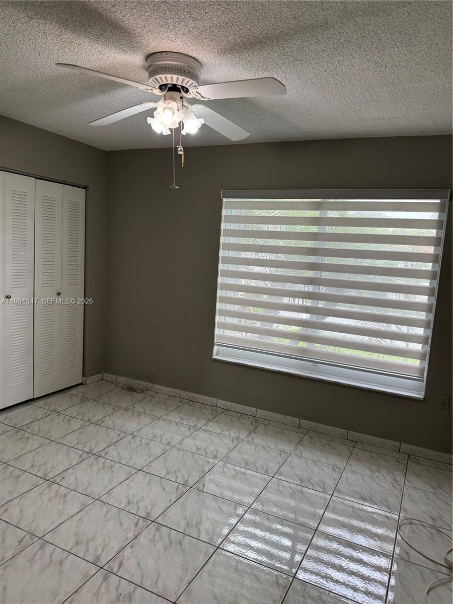 2505 Southwest 126th Avenue Miami, FL 33175 - Photo 21 of 22 a view of a livingroom with a chandelier fan and windows