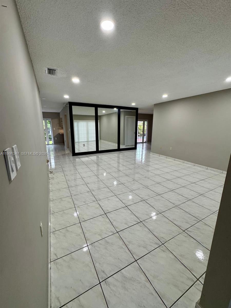 2505 Southwest 126th Avenue Miami, FL 33175 - Photo 3 of 22 a view of a livingroom with wooden floor and a rug