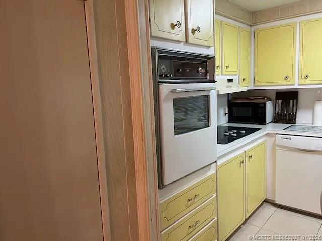 a kitchen with a sink a stove and cabinets