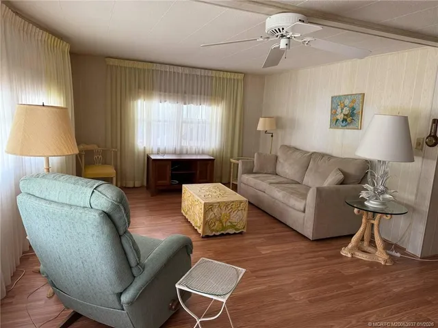 a living room with furniture and a lamp