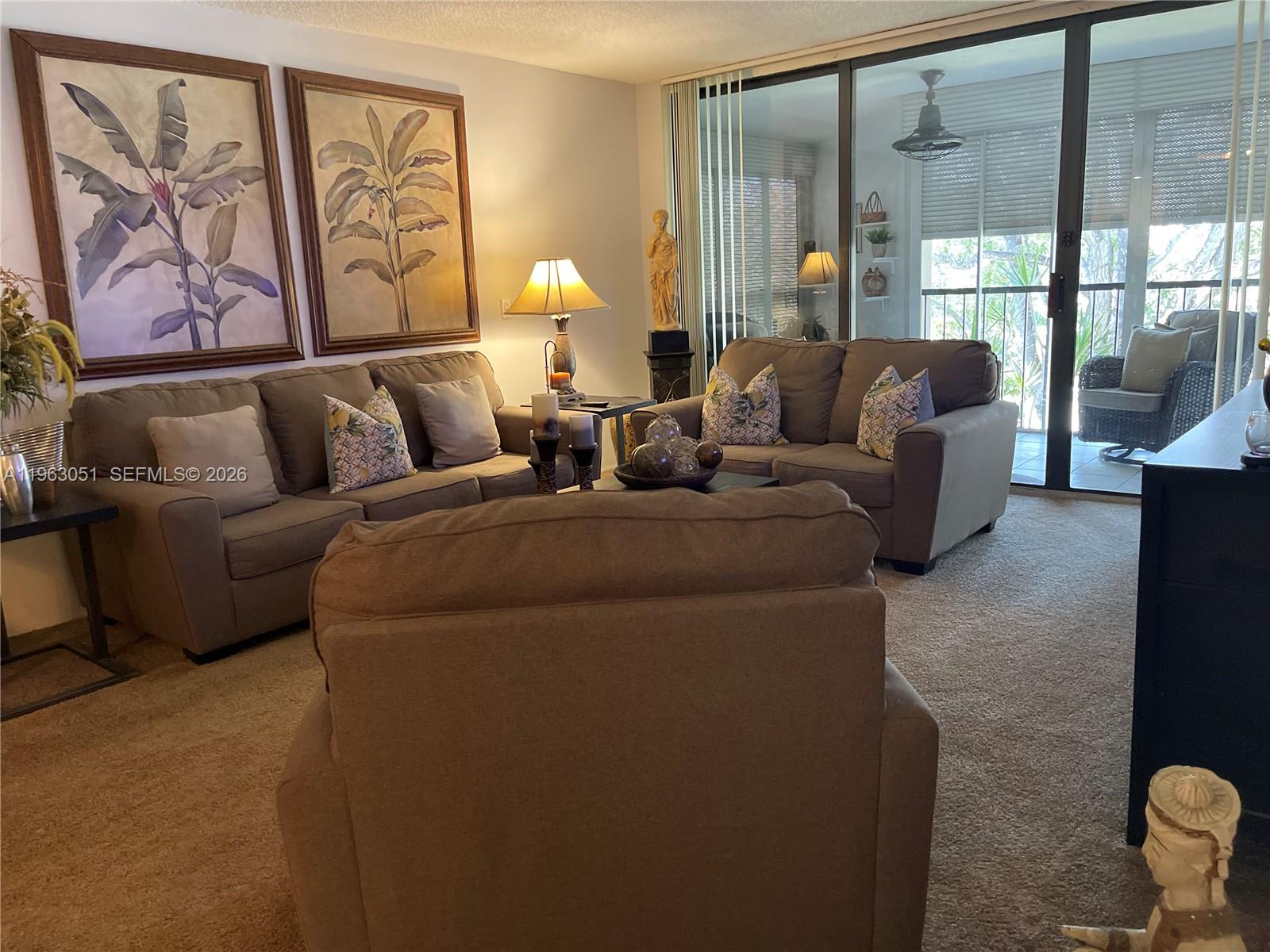 16475 Golf Club Road, Unit 309 Weston, FL 33326 - Photo 11 of 36 a living room with furniture and a large window