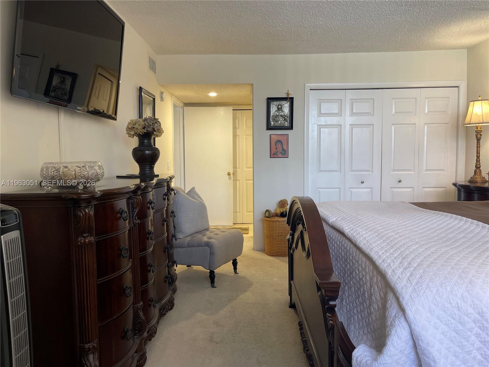 16475 Golf Club Road, Unit 309 Weston, FL 33326 - Photo 12 of 36 a bedroom with a bed and a television