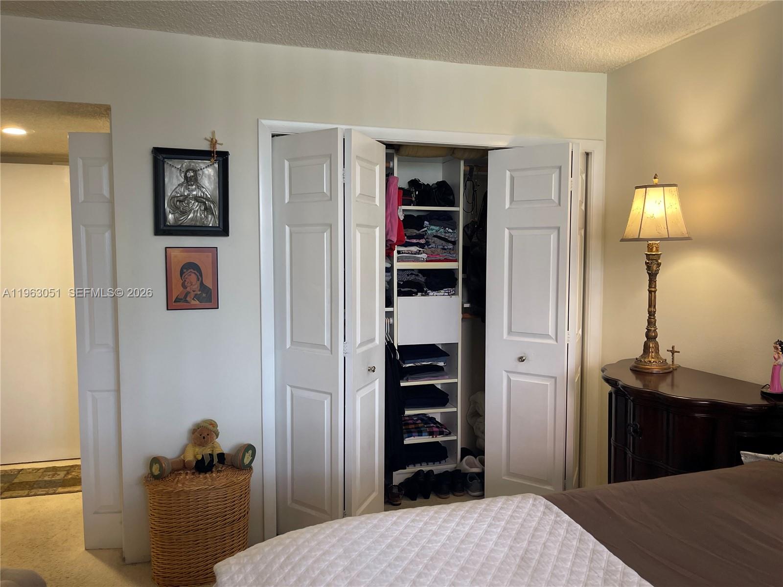 16475 Golf Club Road, Unit 309 Weston, FL 33326 - Photo 16 of 36 a bedroom with a bed and a closet