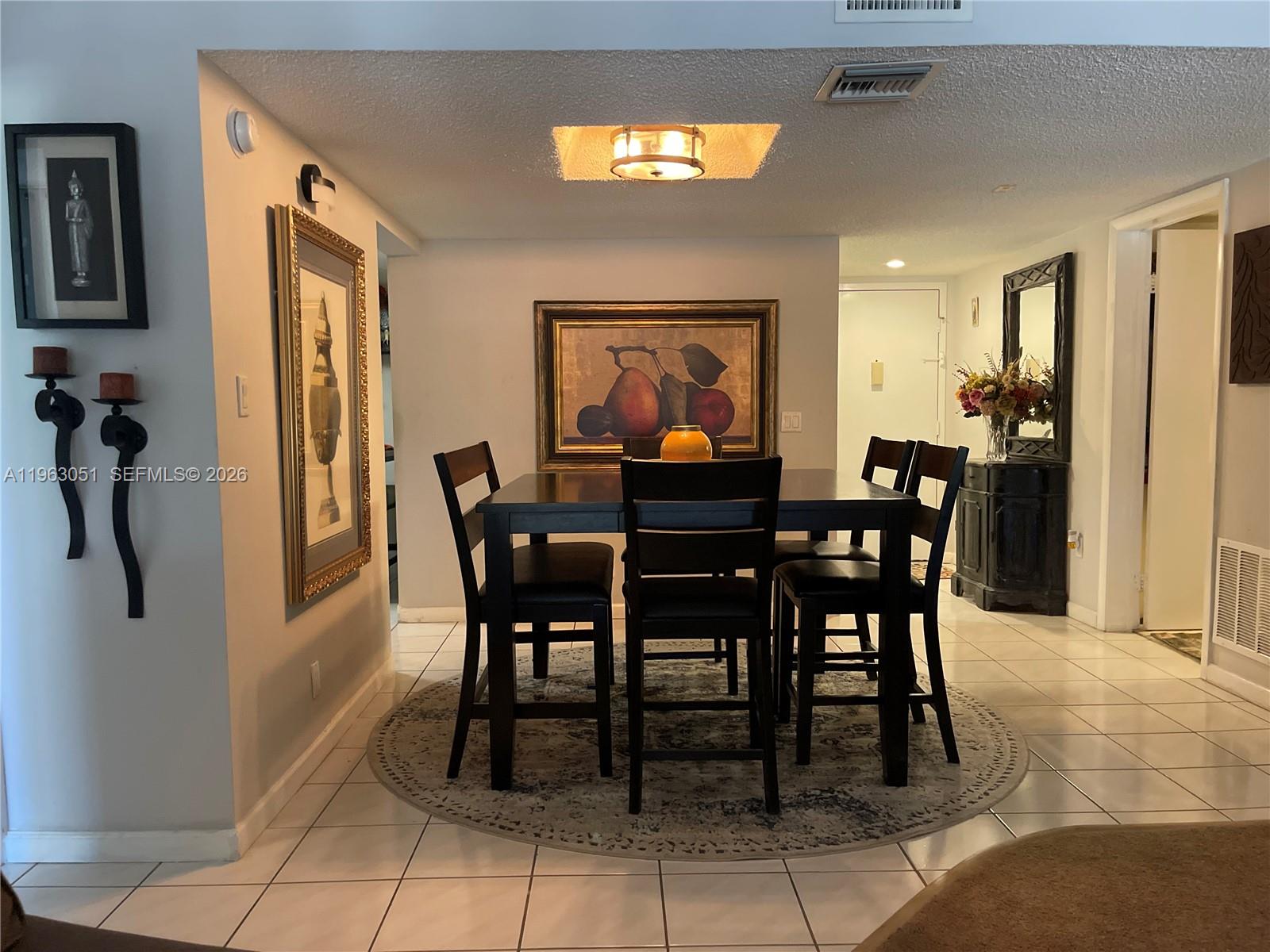 16475 Golf Club Road, Unit 309 Weston, FL 33326 - Photo 2 of 36 a dining room with furniture and window