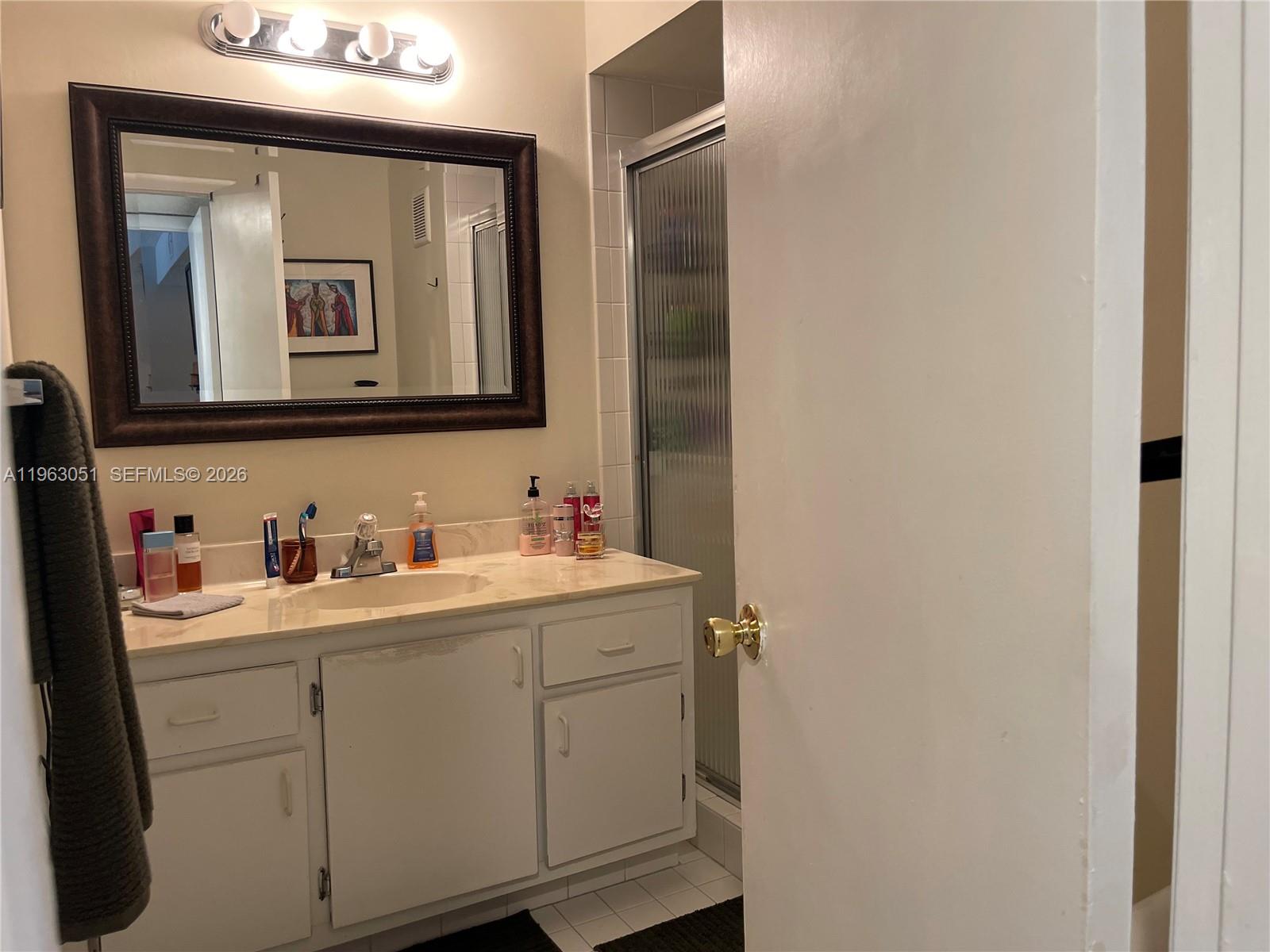 16475 Golf Club Road, Unit 309 Weston, FL 33326 - Photo 23 of 36 a bathroom with a toilet sink and mirror
