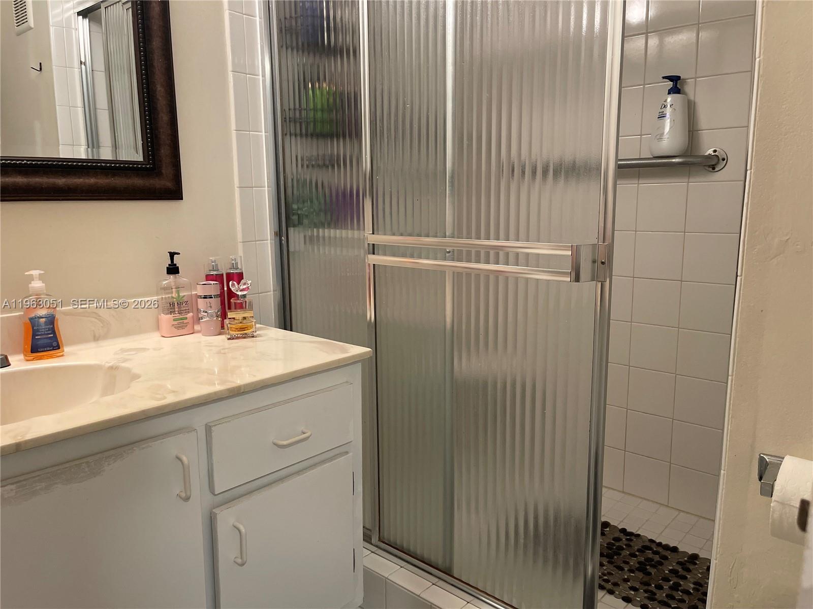 16475 Golf Club Road, Unit 309 Weston, FL 33326 - Photo 24 of 36 a bathroom with a sink and a mirror