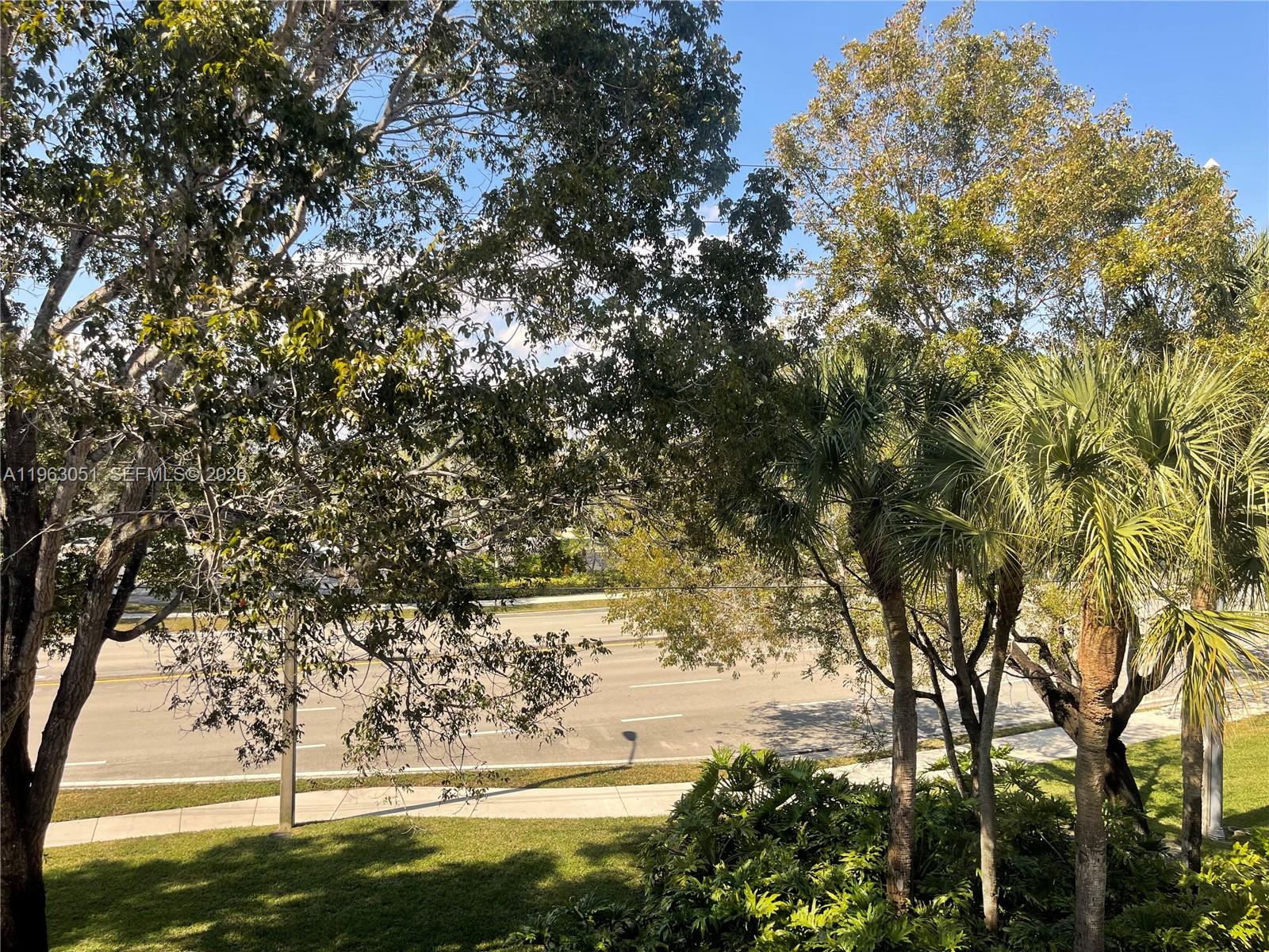 16475 Golf Club Road, Unit 309 Weston, FL 33326 - Photo 28 of 36 a view of a yard with a tree