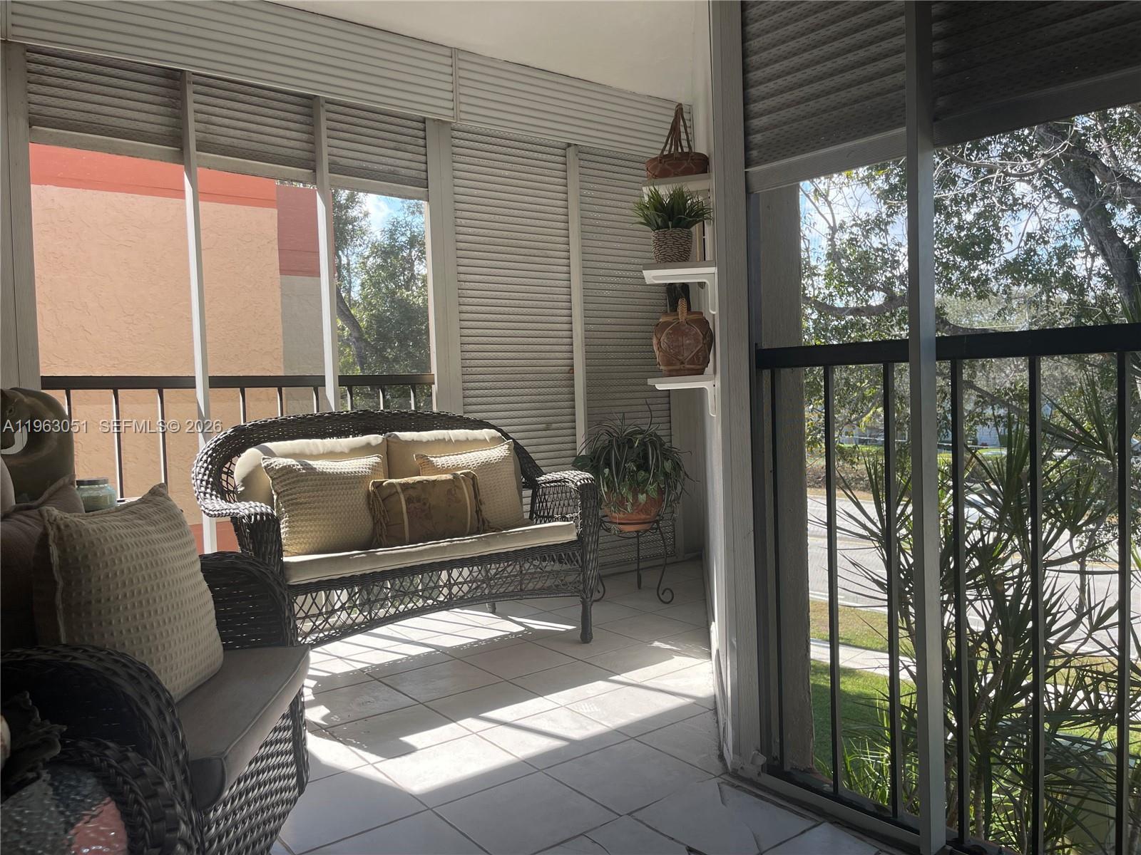 16475 Golf Club Road, Unit 309 Weston, FL 33326 - Photo 29 of 36 a balcony view with a couch and table