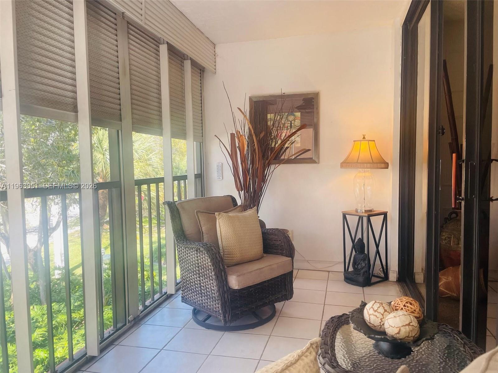 16475 Golf Club Road, Unit 309 Weston, FL 33326 - Photo 30 of 36 a living room with furniture and a floor to ceiling window