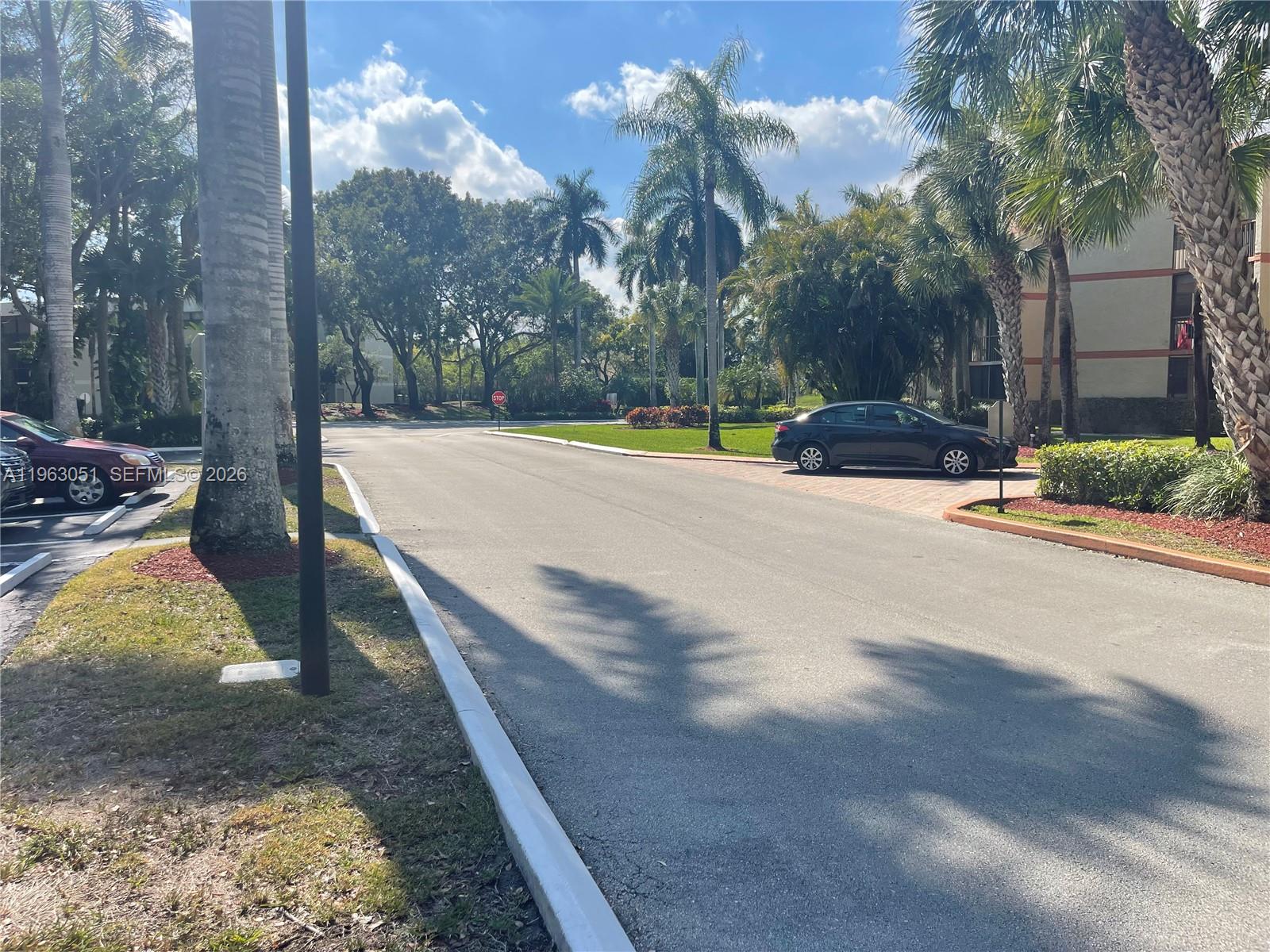 16475 Golf Club Road, Unit 309 Weston, FL 33326 - Photo 36 of 36 a view of a yard with swimming pool and sitting area