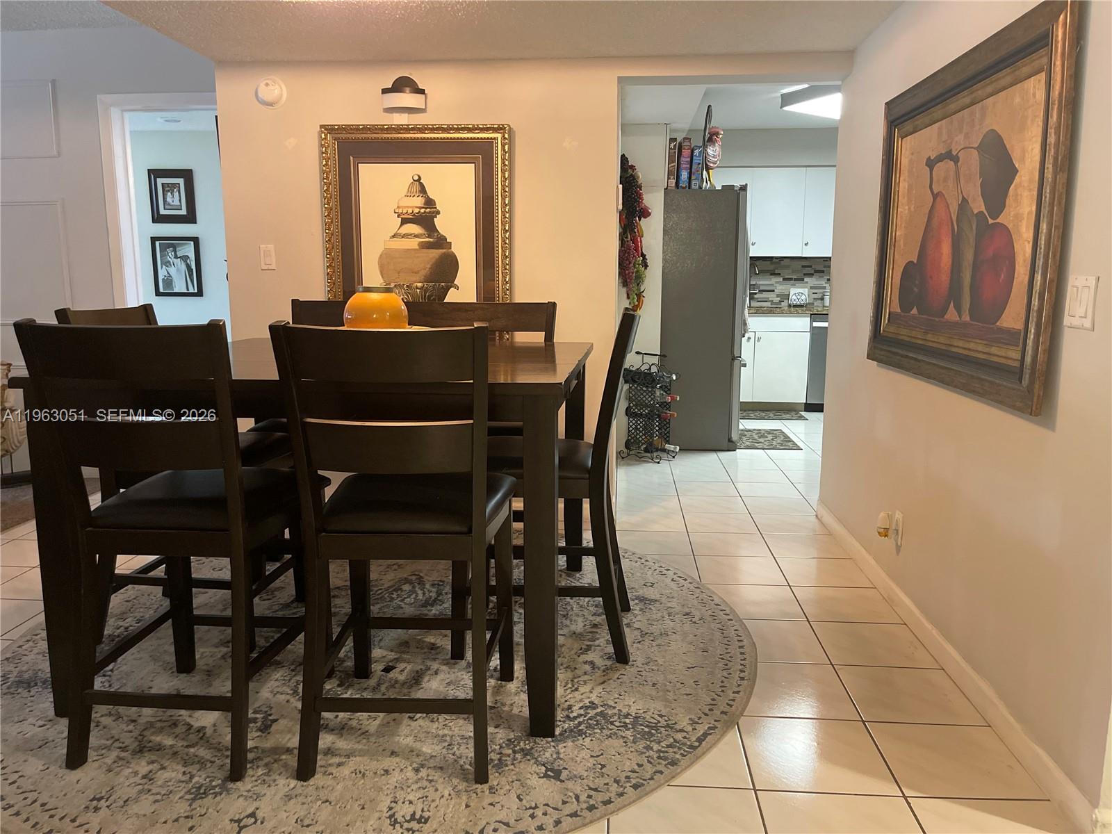 16475 Golf Club Road, Unit 309 Weston, FL 33326 - Photo 4 of 36 a dining room with furniture and window
