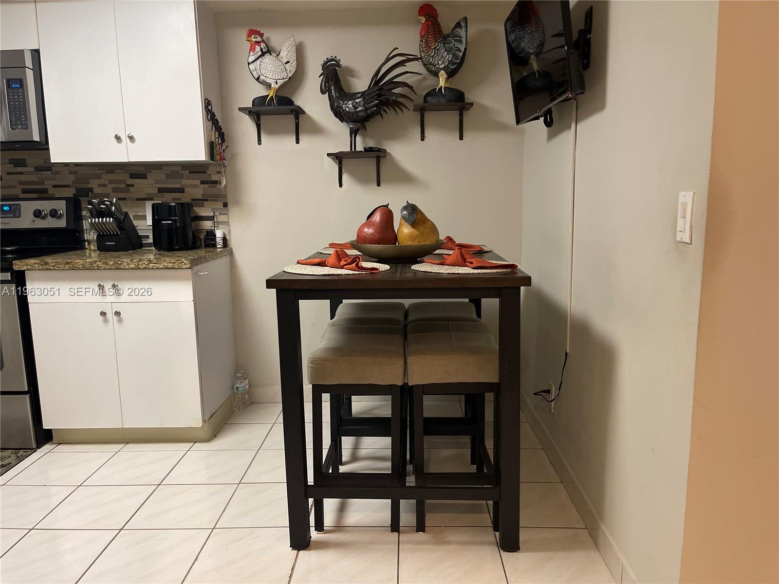 16475 Golf Club Road, Unit 309 Weston, FL 33326 - Photo 6 of 36 a view of a kitchen with appliances and cabinets