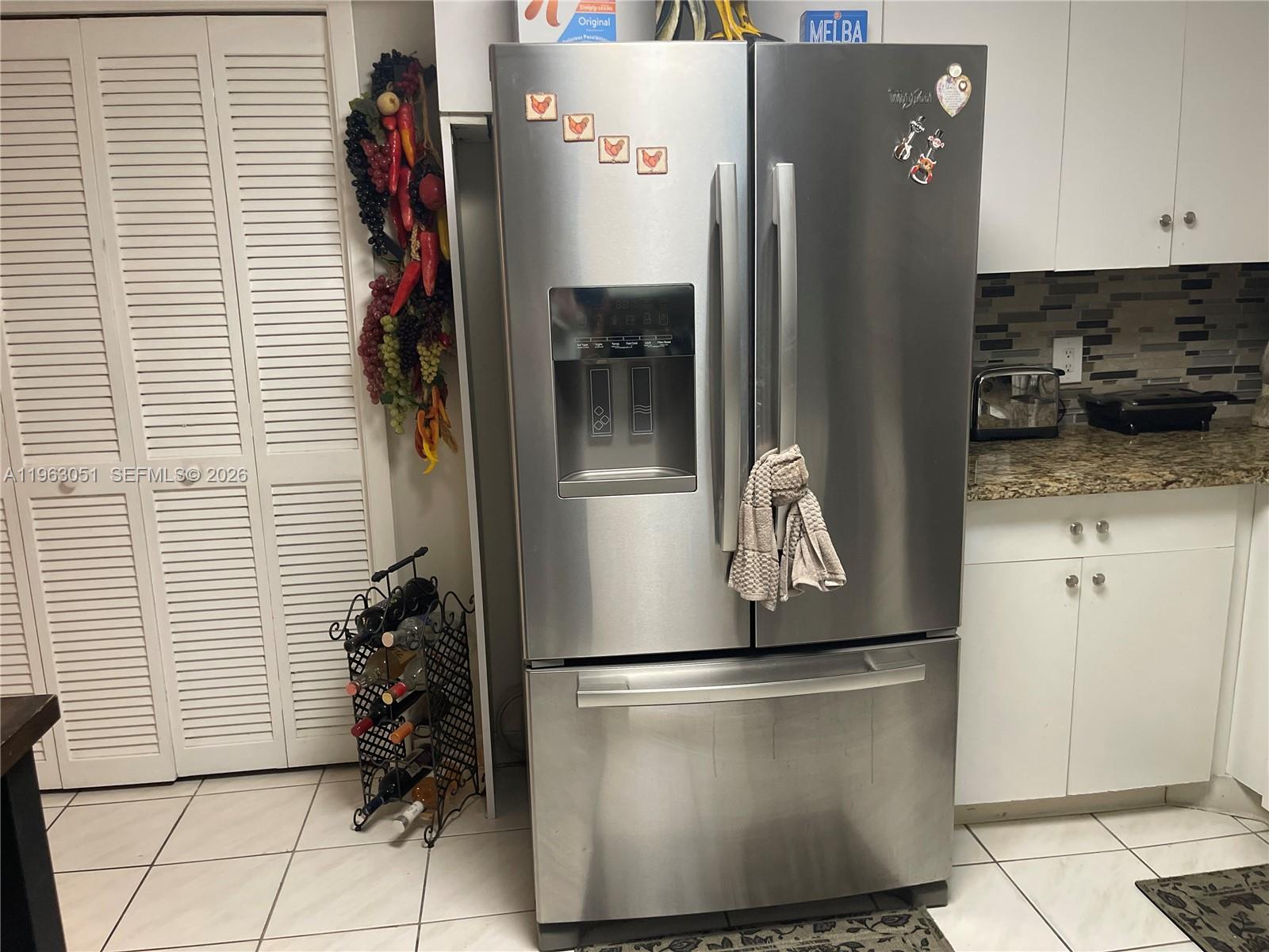 16475 Golf Club Road, Unit 309 Weston, FL 33326 - Photo 7 of 36 a kitchen with a refrigerator and a stove