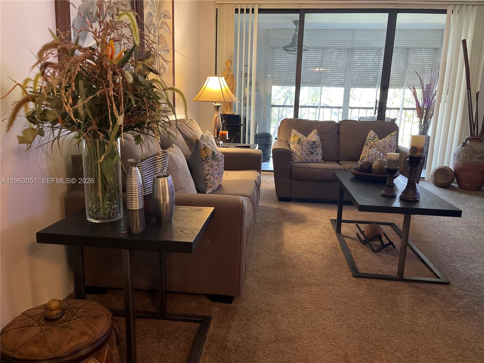 16475 Golf Club Road, Unit 309 Weston, FL 33326 - Photo 9 of 36 a living room with furniture and a window