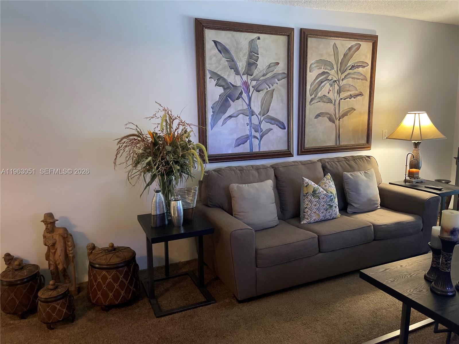 16475 Golf Club Road, Unit 309 Weston, FL 33326 - Photo 10 of 36 a living room with furniture a couch and a potted plant