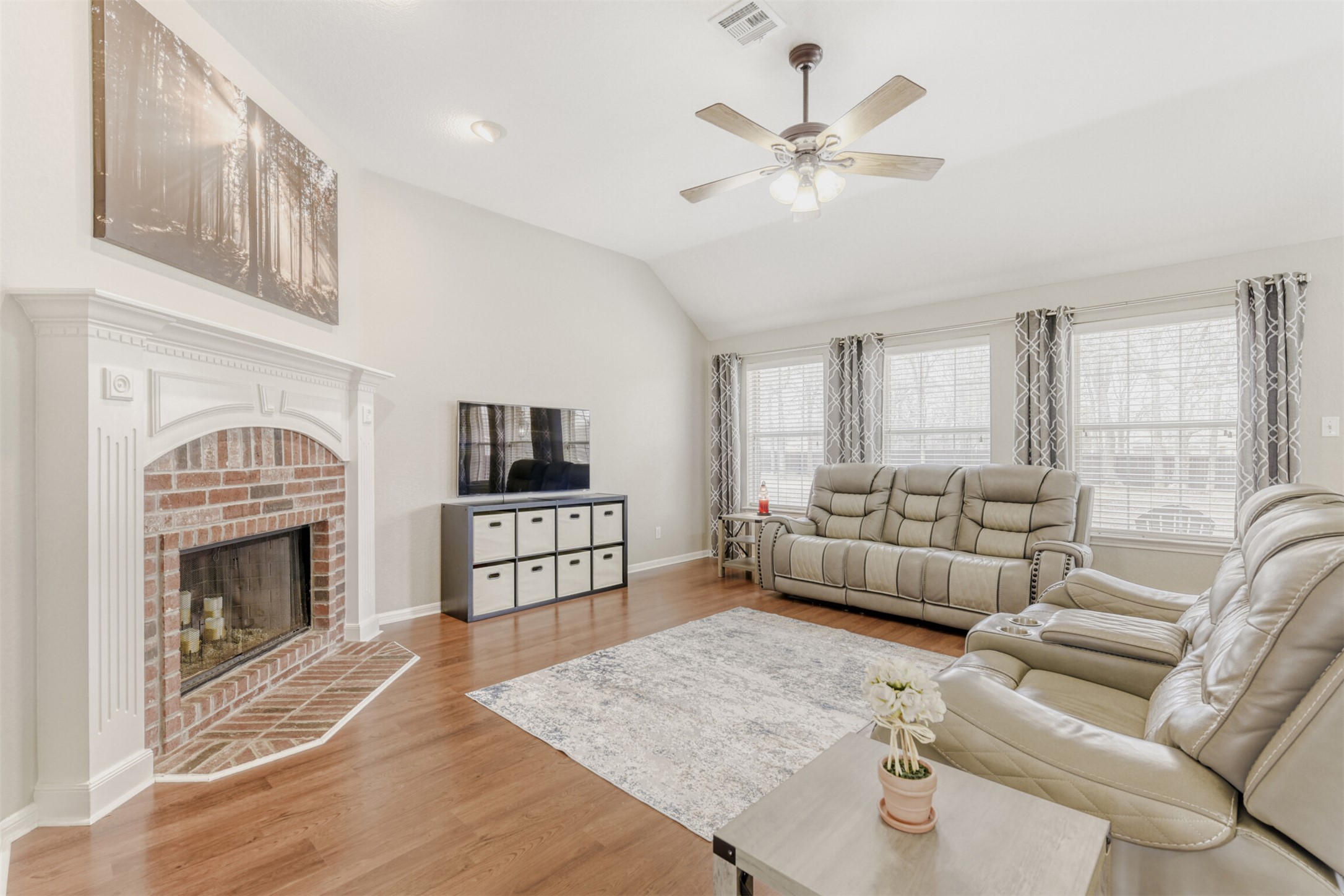 104 Spring Branch Bastrop, TX 78602 - Photo 12 of 32 Living area featuring a fireplace, light wood finished floors, lofted ceiling, and ceiling fan