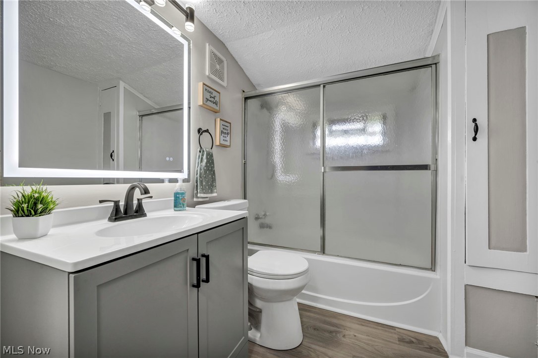 1603 Winchester Road Lyndhurst, OH 44124 - Photo 21 of 34 Upstairs, stylishly renovated bathroom featuring a modern LED mirror, updated vanity, and new flooring for a clean, fresh look.