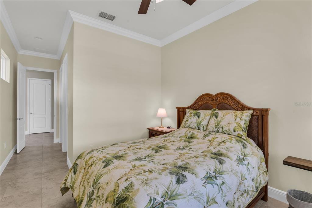 2665 Meadowedge Loop St. Cloud, FL 34772 - Photo 38 of 53 a bedroom with a bed and a lamp