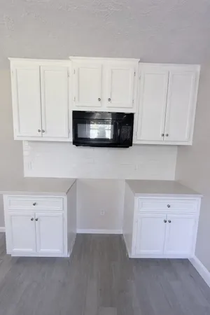 a kitchen with stainless steel appliances white cabinets and a sink