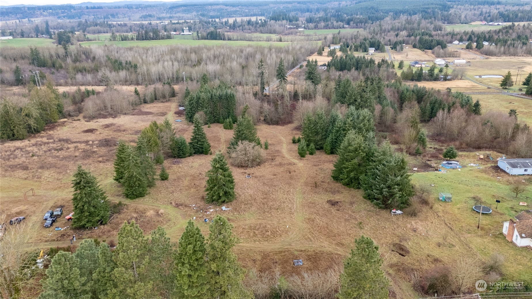 an aerial view of a houses with outdoor space and trees