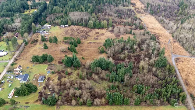 an aerial view of mountain with yard
