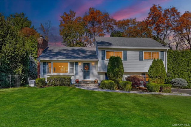 a front view of a house with a garden and plants