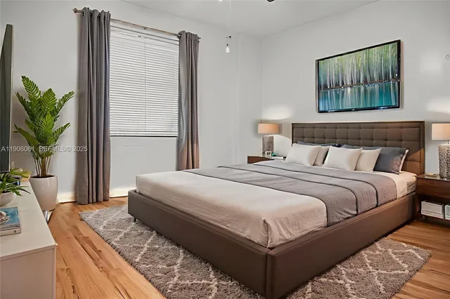 a bedroom with bed and window