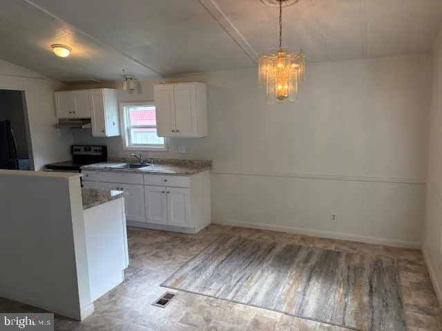 a kitchen with a sink cabinets and window