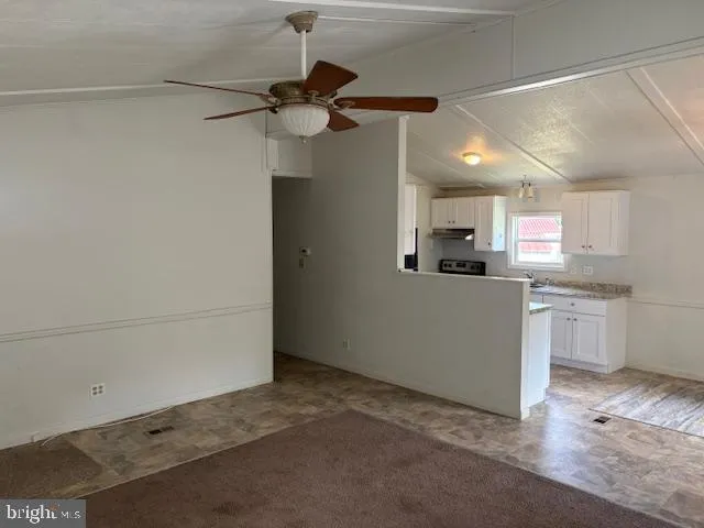 a view of a kitchen with a sink and dishwasher a refrigerator with wooden floor
