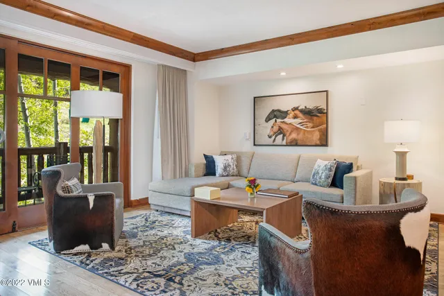 a living room with furniture and a potted plant