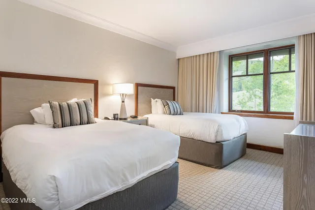 a bedroom with bed and a large window