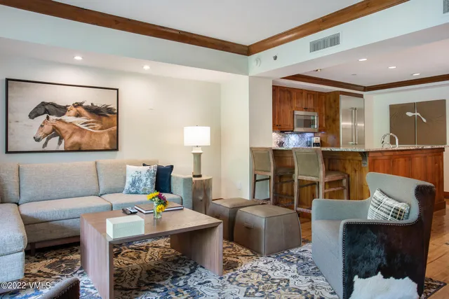 a living room with furniture a couch and wooden floor