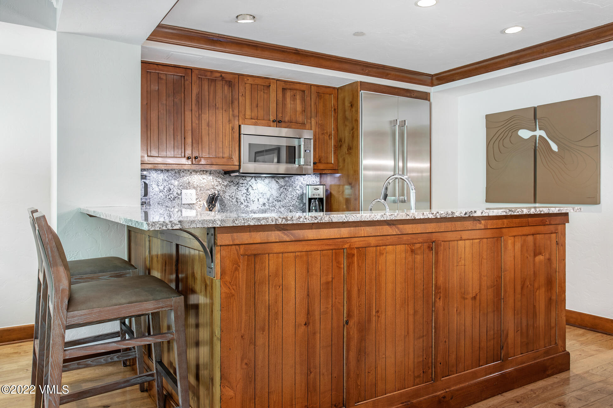 100 Bachelor Ridge Road, Unit 3402 Avon, CO 81620 - Photo 10 of 54 a kitchen with kitchen island granite countertop wooden cabinets and stainless steel appliances