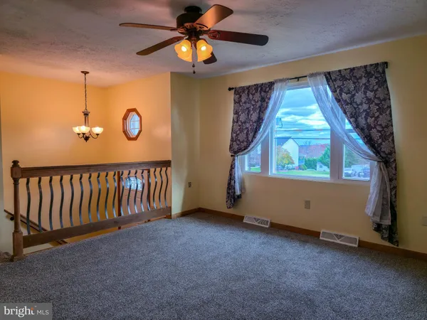 a view of a hallway with a chandelier