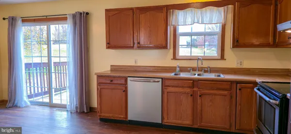 a kitchen with a sink stove and refrigerator