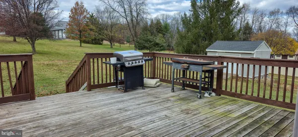 a view of a wooden deck and a yard